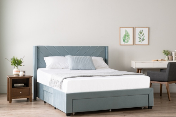 Grey bed frame with built-in drawers.